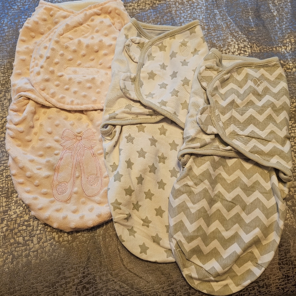 Set of three SwaddleMe size small swaddles.